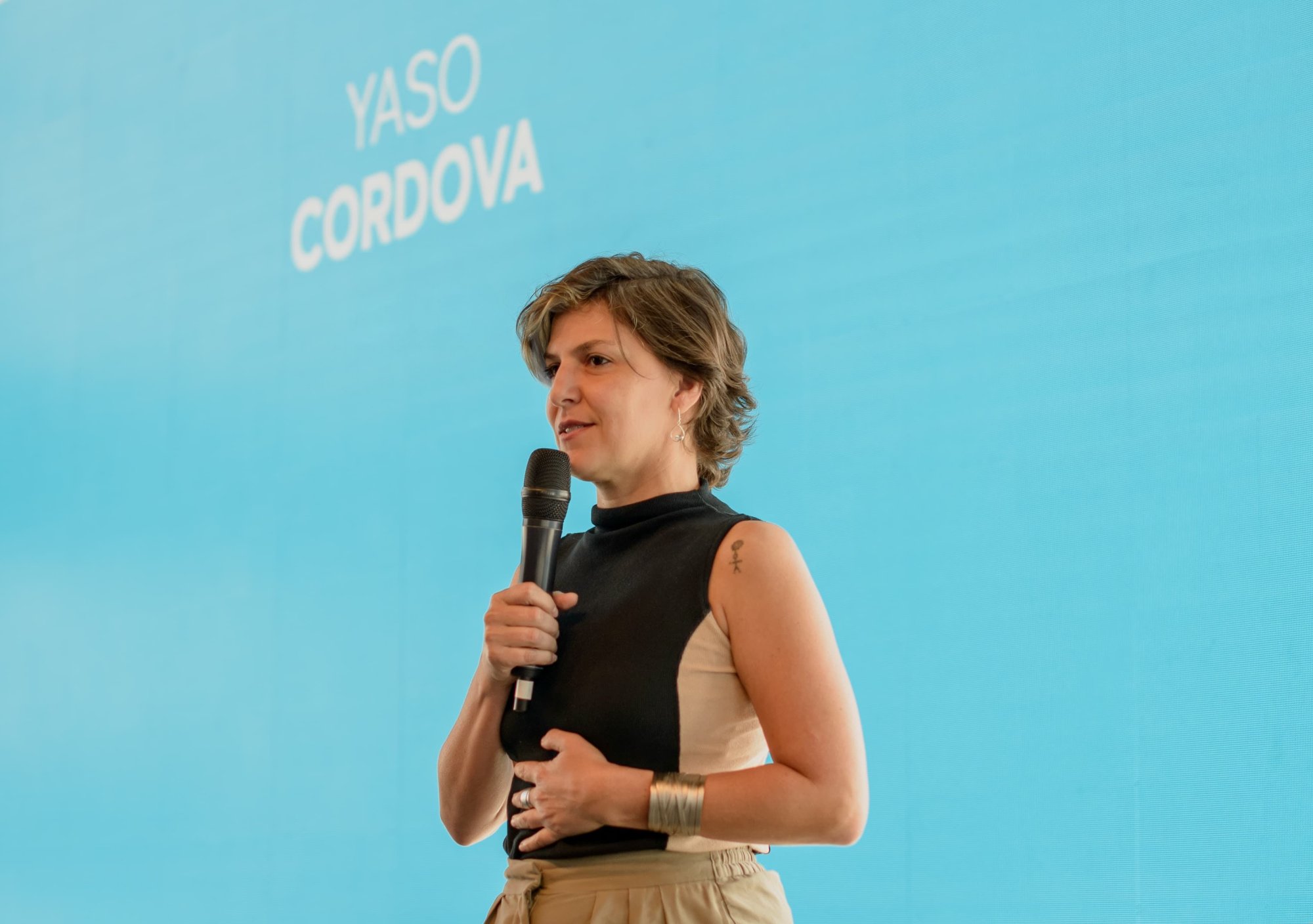 Yasodara Córdova speaking on stage